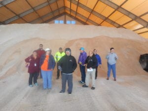 clients in front of a sand pile